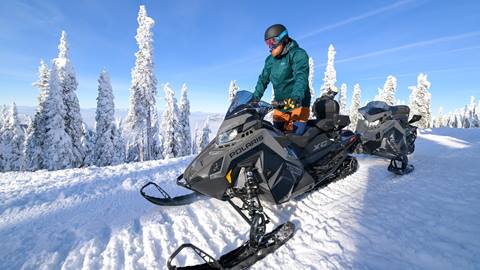 person riding snowmobile on guided snowmobile tours at schweitzer mountain