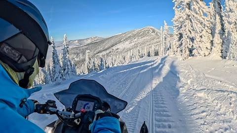 pov of person snowmobiling on trail on schweitzer mountain guided tour