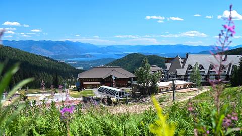 photo of Schweitzer Village with fireweed and blue skies