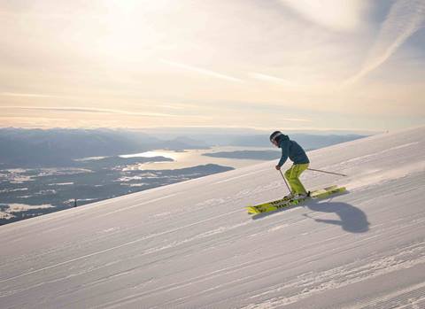 skier on sunny day with lake pend oreille in background
