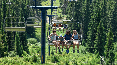 family on chairlift in the summer
