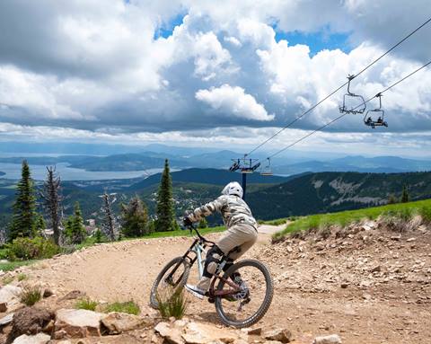 mountain biker riding on a trail with a cross country mountain bike rental at schweitzer with panoramic views and open terrain