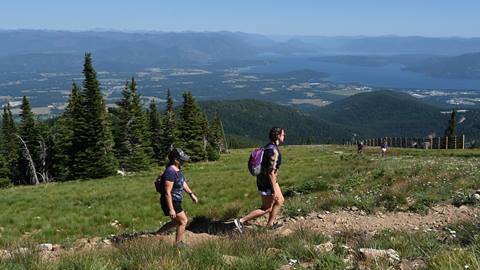 Mom and Daughter hiking at the summit of Schweitzer on a summer day