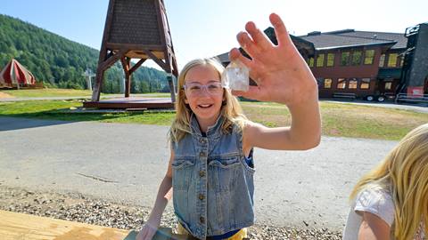kid with rock from sluice pass