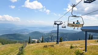 people riding chairlift in the summer at Schweitzer
