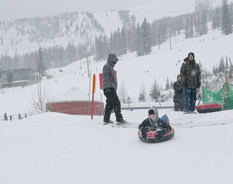 kid snow tubing fun at hermit's hollow schweitzer mountain resort