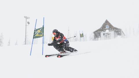 nastar alpine racing skier in snowy fog conditions at schweitzer