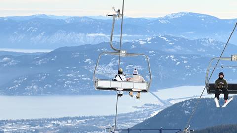 couple riding down chairlift at Schweitzer 