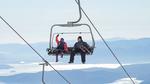 Snowshoeing adventurers on a schweitzer chairlift