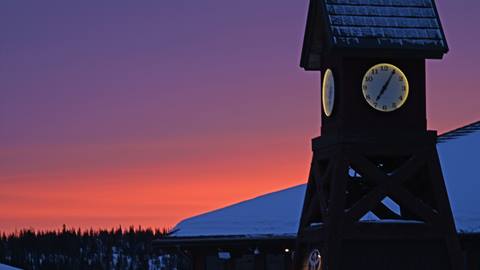 sunset over clocktower during night skiing at schweitzer mountain