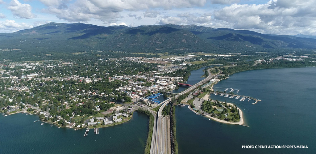 Downtown Sandpoint and City Beach with Schweitzer Mountain in the background on a summer day. Photo credit Action Sports Media