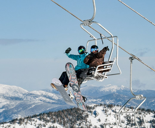 two snowboarders on a lift