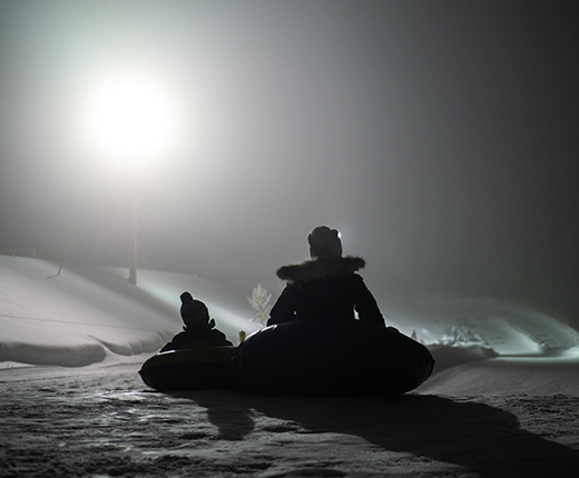 evening tubing session under the lights