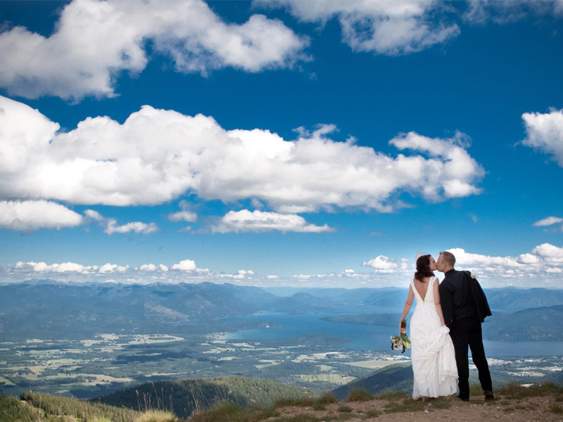 couple kissing on summit of mountain